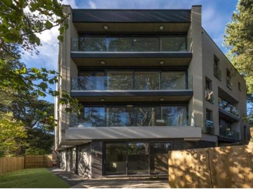 a large building with a lot of windows at Luxury 3 bed flat with large terrace, sea views and hot tub in Canford Cliffs