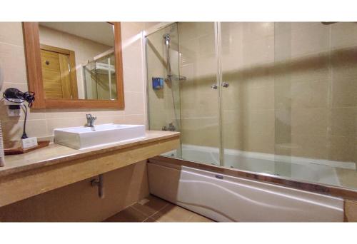 a bathroom with a sink and a shower at Westport Istanbul Resort & Spa Hotel in Silivri