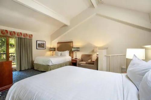 a hotel room with two beds and a chair at Aspen at Streamside at Vail in Vail