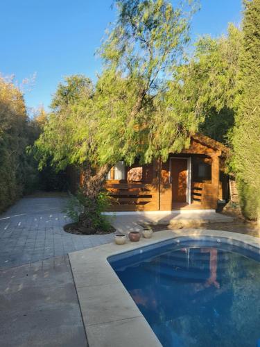 a swimming pool in front of a house at Casa Madera Urbanizacion Socorro in Seville