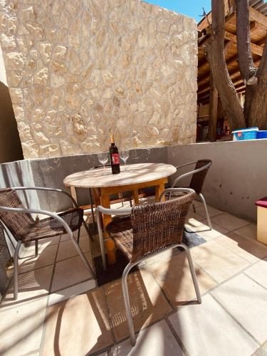 a table and chairs with a bottle of wine on a patio at Apartments with parking space Metajna, Pag - 527 in Metajna