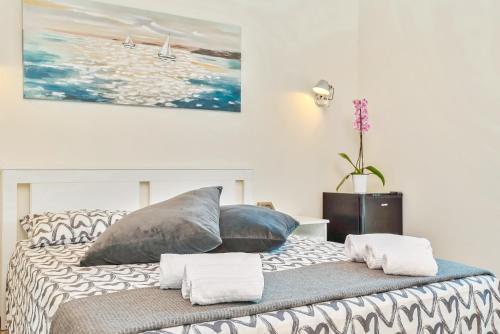 a bedroom with a large bed with pillows on it at Hotel la Pietra restaurant in Fosdinovo