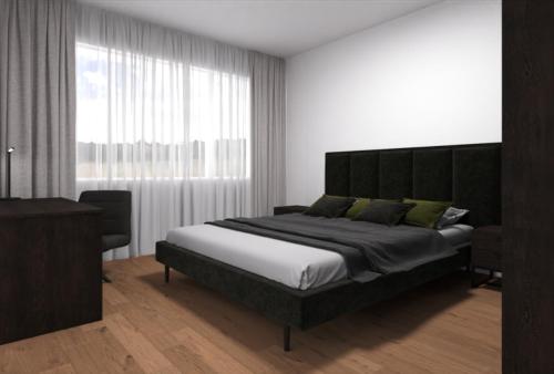 1 dormitorio con cama grande y ventana grande en MOOI Apartments Grenchen, en Grenchen