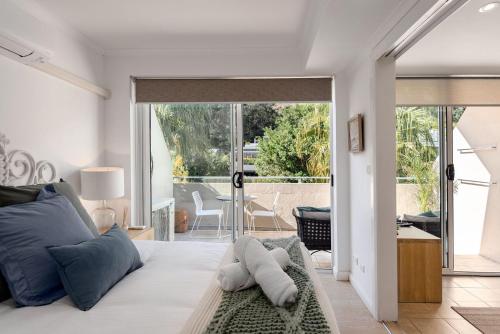 a bedroom with a bed with blue pillows at Oceans Eleven at Iluka Resort Apartments in Palm Beach