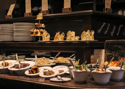 a buffet with plates of food on a table at SPREE Hotel in der Altstadt in Lübbenau