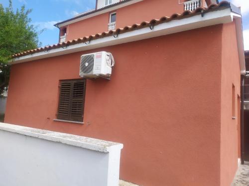 a building with a air conditioner on the side of it at Hotel Livadic & Restaurant in Ližnjan