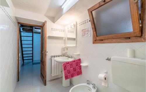 a bathroom with a toilet and a sink and a mirror at Casa Andrea in Culla