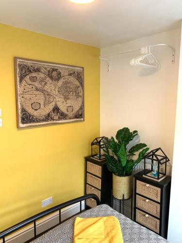a bedroom with a bed and a painting on the wall at Cosy Wirral home near Liverpool with Free Parking! in Birkenhead