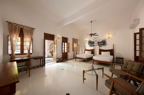 a large living room with a bed and a table at Grand Hotel D'Europe in Puducherry