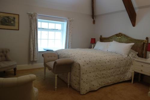 a bedroom with a large bed and a window at The East Wing in Glasbury