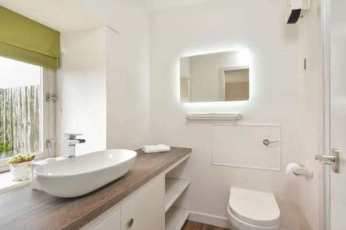 a white bathroom with a sink and a toilet at Meggie Allans in Crail