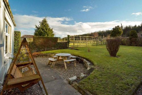 a garden with a table and a picnic table at Kittocks Muir in St. Andrews