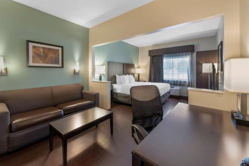 a hotel room with a bed and a couch at Best Western Hilliard Inn & Suites in Hilliard