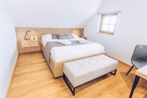 a bedroom with a bed and a desk and a chair at Tri lučke Hotel & Restaurant in Krško