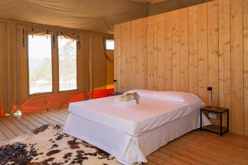 a bedroom with a bed in a room with wooden walls at Tenuta San Lodovico in Scansano