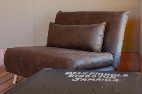 a brown leather chair with a pillow on it at Tenuta San Lodovico in Scansano