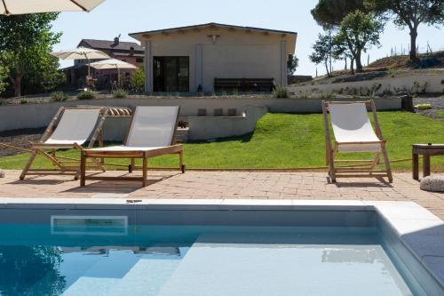 two chairs sitting next to a swimming pool at Tenuta San Lodovico in Scansano