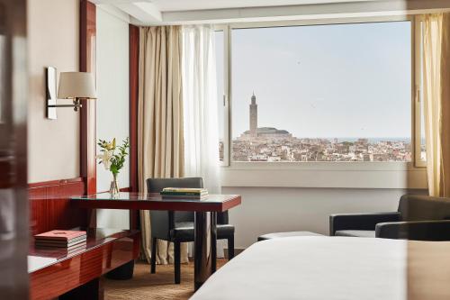 a hotel room with a desk and a window at Hyatt Regency Casablanca in Casablanca