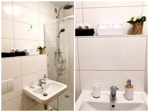 a white bathroom with a sink and a shower at 2 Zimmer für 3 Personen in Essen in Essen