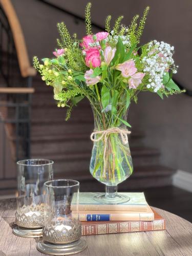 a vase of flowers sitting on top of a book at Ludvika Stadshotell in Ludvika