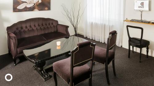 a living room with a couch and chairs and a table at Center Hotels Skjaldbreid in Reykjavík
