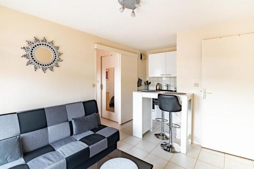 un salon avec un canapé et une cuisine dans l'établissement Le Grand Cap, à Villers-sur-Mer