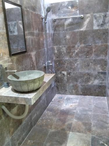 a bathroom with a bowl sink and a shower at The Natural Bungalow in Hoi An