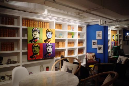 a room with a table and a painting on the wall at Mini Hotel Causeway Bay in Hong Kong