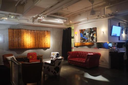 a living room filled with furniture and a tv at Mini Hotel Causeway Bay in Hong Kong