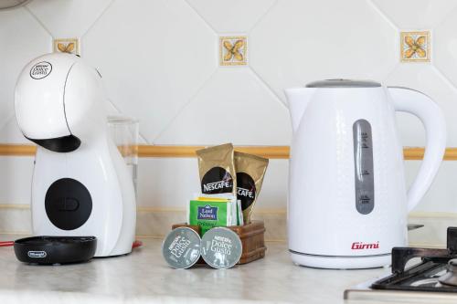 a coffee maker and a toaster on a kitchen counter at [VILLA LECCO] FREE Wi-Fi, Parking & Bike Service in Lecco
