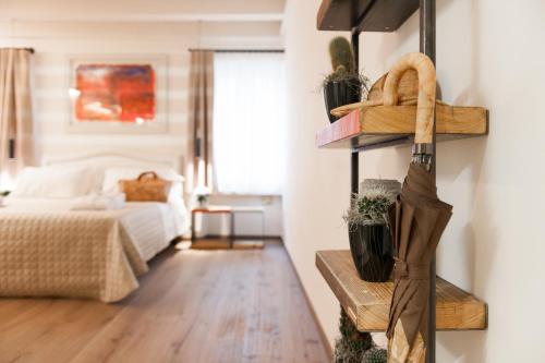 a room with a bed and a room with wooden floors at Verona Suites in Verona