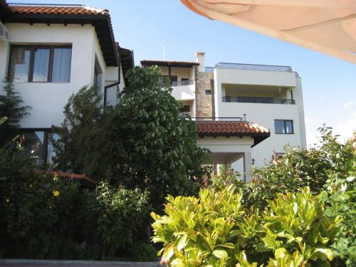 a white building with trees in front of it at Hotel Villa Ofir in Sandanski