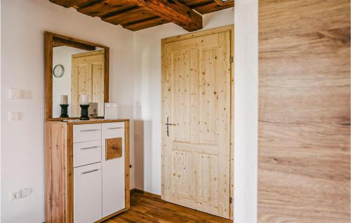 a room with a wooden door and a kitchen at Ferienhaus Gaas Weinberg in Gaas