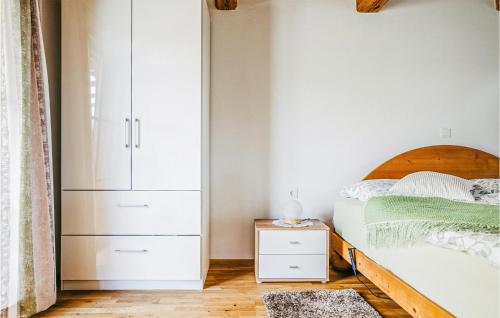 a bedroom with a bed and a white cabinet at Ferienhaus Gaas Weinberg in Gaas