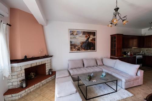 a living room with a couch and a fireplace at Τα ανετα διαμμερισματα του Λεκα in Zakharo