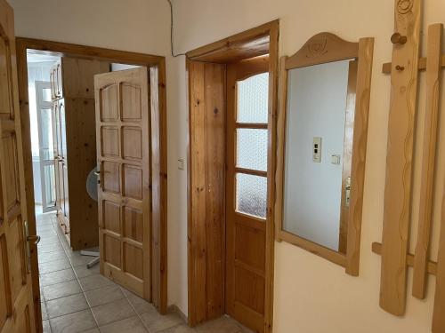 a hallway with two doors and a window at Apartments Panorama Ravda in Ravda