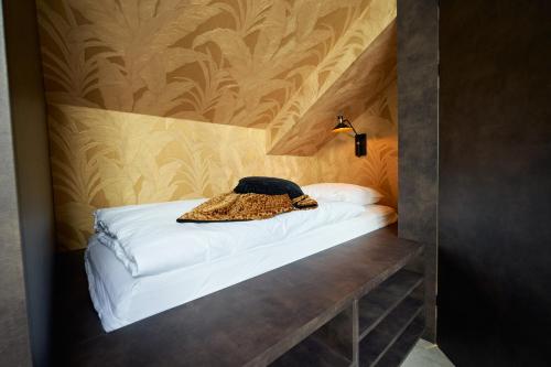a bed with a leopard coat on it in a room at Nomad Water Lodge in Harderwijk