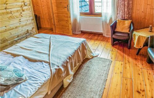 a bedroom with a bed and a chair and a table at Nice Home In Ustka With Wifi in Ustka