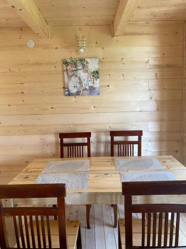a wooden dining room with a wooden table and chairs at Peaceful Oasis in Ulcinj