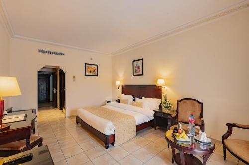 a hotel room with a bed and a desk at Aquafun By Grand Mogador Agdal in Marrakech