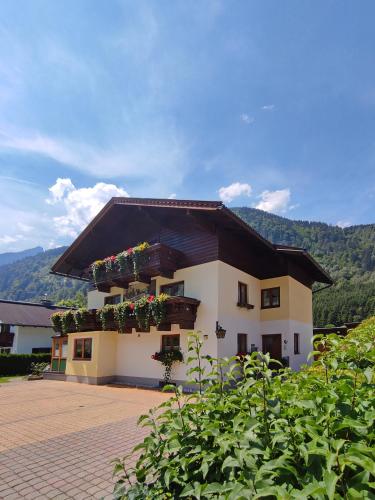 a building with flower boxes on the side of it at Haus Hubertus in Fusch an der Glocknerstraße