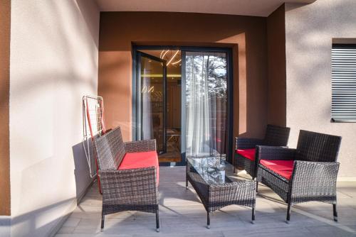 a group of chairs with red cushions on a patio at Balkan Hill Zlatibor in Zlatibor
