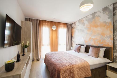 a bedroom with a bed and a large window at Romantic getaway at West Residence in Oradea
