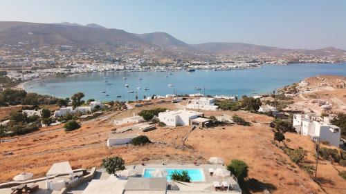 an aerial view of a bay with boats in the water at Blue Bay Heliolithos in Parikia