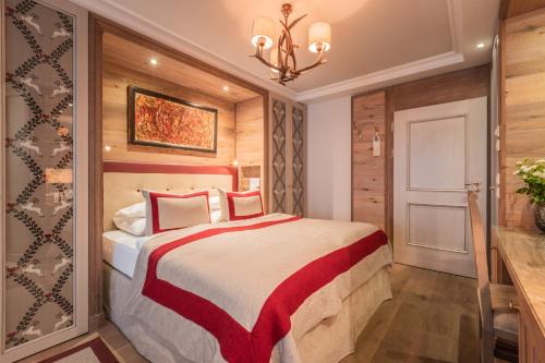 a bedroom with a bed and a chandelier at Alpin Resort Sacher in Seefeld in Tirol