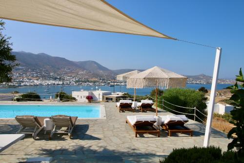 a resort with a pool and chairs and a view at Blue Bay Heliolithos in Parikia