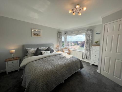 a bedroom with a large bed and a window at The Emberton in Bridlington