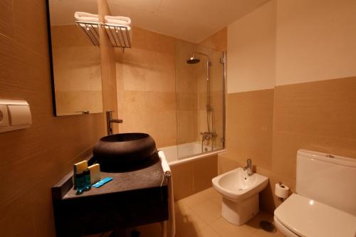 a bathroom with a sink and a toilet and a shower at YIT El Postigo in Úbeda