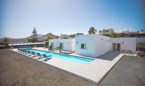a villa with a swimming pool and a house at Casa Conil with a private 25 meter heated pool in Conil