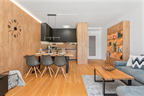 a kitchen and living room with a table and a couch at Apartmán Molo Lipno in Lipno nad Vltavou